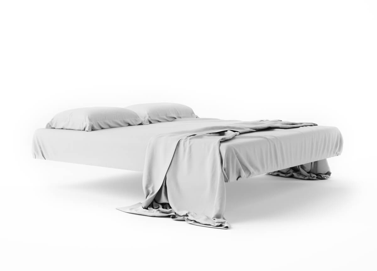 lewitujące łóżko na białym tle